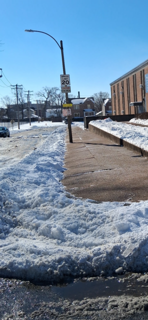 Cleared sidewalk and street after snow removal